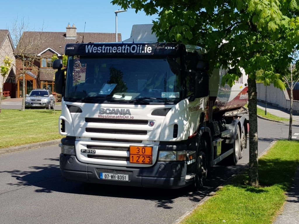 Westmeath Oil truck delivering oil to a satisfied customer