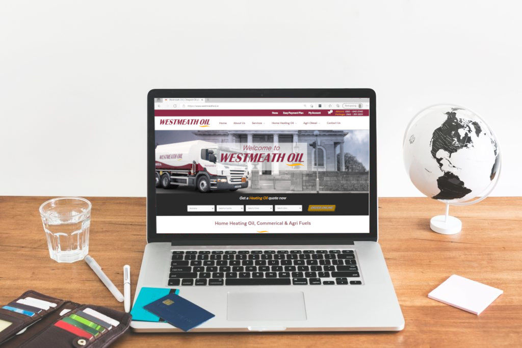 A laptop displaying the Westmeath Oil website home page